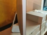 a computer monitor sitting on top of a wooden desk