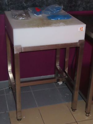 a sink in the corner of a bathroom with a purple wall