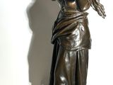 statue of a woman with a bird on her shoulder