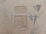 a small stamp on the ground that has a bird on it