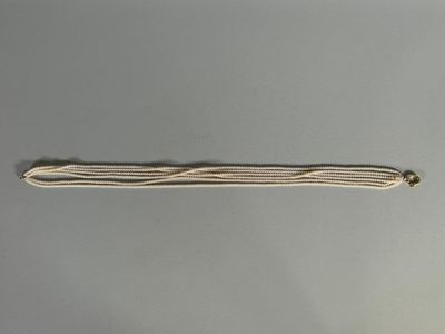a close up of a piece of string with a small bead on it