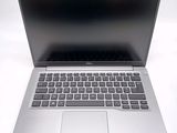 an open laptop computer sitting on top of a white table