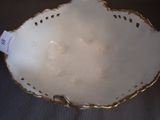 a white bowl with gold trim and a tag on it