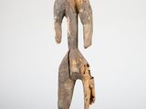 an old wooden statue of a man with a hat on his head