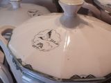 a close up of a pot with a lid on a table