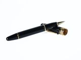 a pen that is laying on top of a white surface