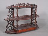 a wooden shelf with a drawer underneath it
