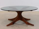 an image of a table with a glass top on a concrete floor
