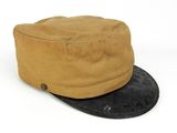 beige and black hat with leather brimle on top of it