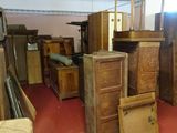 a room filled with lots of wooden furniture and a red carpet