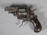 an old gun with a wooden handle on a white surface