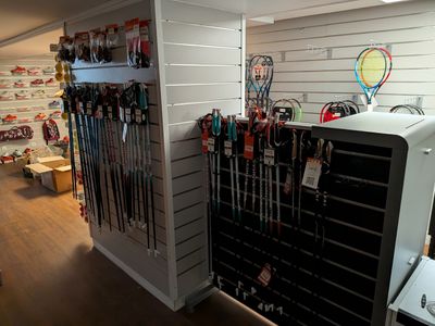 many skis and ski poles on display in a store