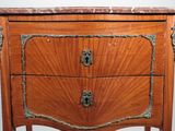 a wooden chest of drawers with a marble top