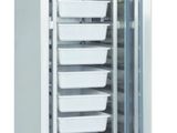 a close up of a freezer with four trays of food inside of it