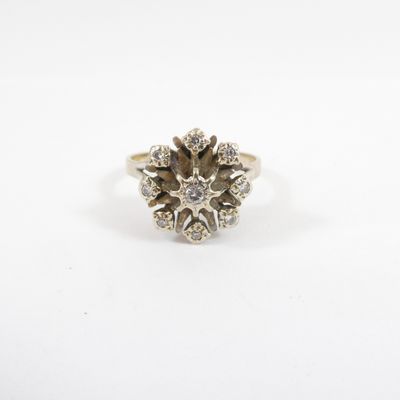 a white gold ring with a cluster of diamonds in the center