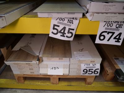 boxes of wood are stacked on pallets for sale at a store
