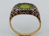 Gros plan sur une bague contenant une pierre verte