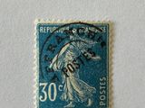 an old stamp with a woman on it on a white surface