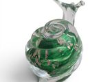 a glass snail that is sitting on a white surface