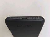 the back of a black cell phone sitting on top of a white table