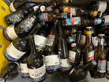 many bottles of beer in a bin on the floor