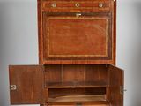 a wooden cabinet with a sliding door on wheels