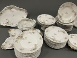 a lot of plates and bowls on the table