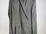 grey suit on a hanger against a white wall