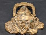 a gold statue of a man with a hat on it