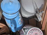 a cardboard box filled with assorted items including a coffee pot, tea pot, and a helmet