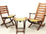 two chairs and a table in a room with a white wall