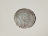 a close up of a coin on a white surface