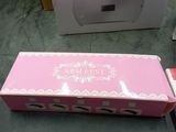 packaging of a pink box with a white design on it