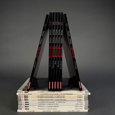 a stack of books sitting on top of each other on top of a table