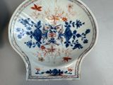 a blue and white plate with a flower design on it