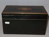 an old black box with gold trim and a black lid