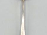 a close up of a spoon with a flower design on it