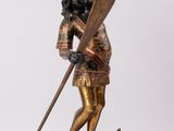 figurine en bronze représentant un homme dans un bateau, muni d'une pagaie