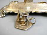 a silver candle holder with a teapot on it