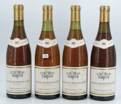 four bottles of wine are lined up on a white surface