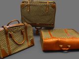 three pieces of luggage sitting next to each other on a gray surface