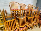 a lot of wooden chairs and tables in a room