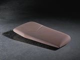 a pink object on a black surface with a black background