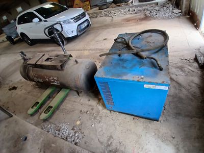 deux voitures garées dans un garage à côté d'une machine bleue