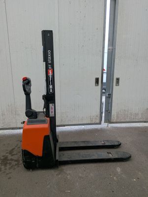 a picture of a forklift truck parked in front of a building