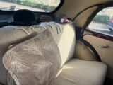 a couch with a hat on top of it in the back of a car