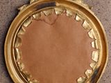 a gold plate with a crown on it on a table