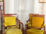 deux chaises jaunes dans une pièce où se trouve une bibliothèque