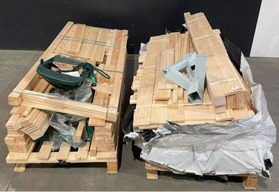 two wooden pallets with tools on them on the floor