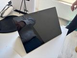 a laptop computer sitting on a table next to a pair of shoes